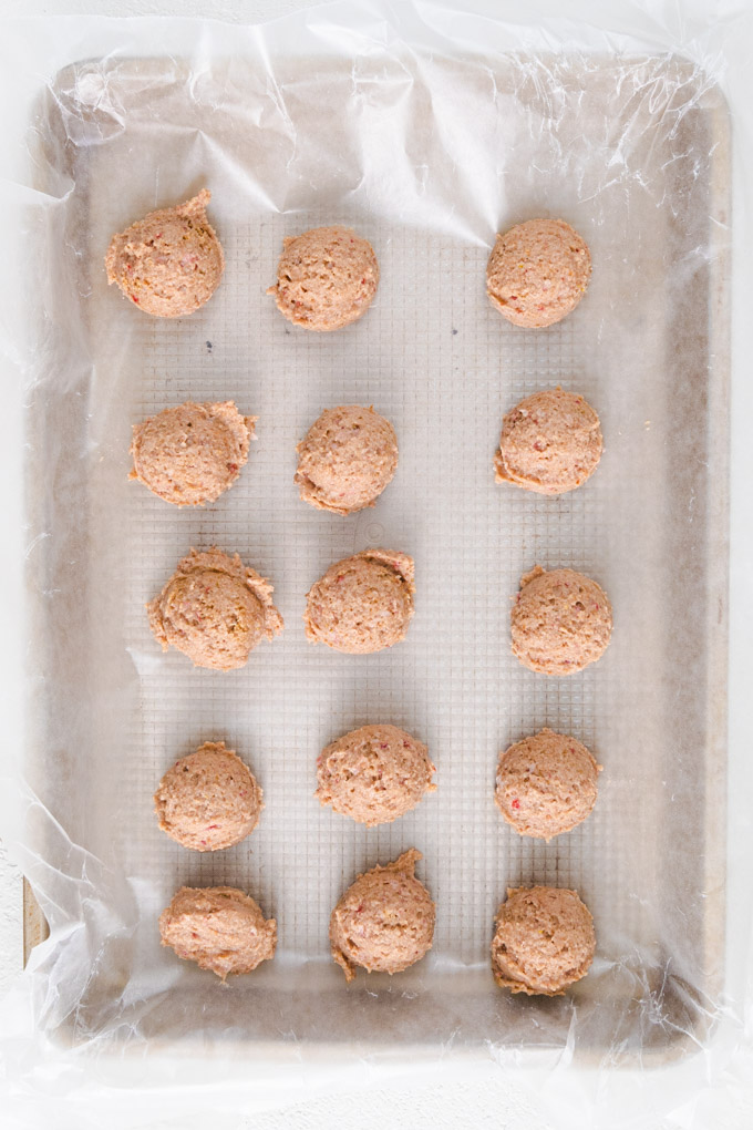 strawberry shortcake bites on a baking sheet lined with wax paper. 