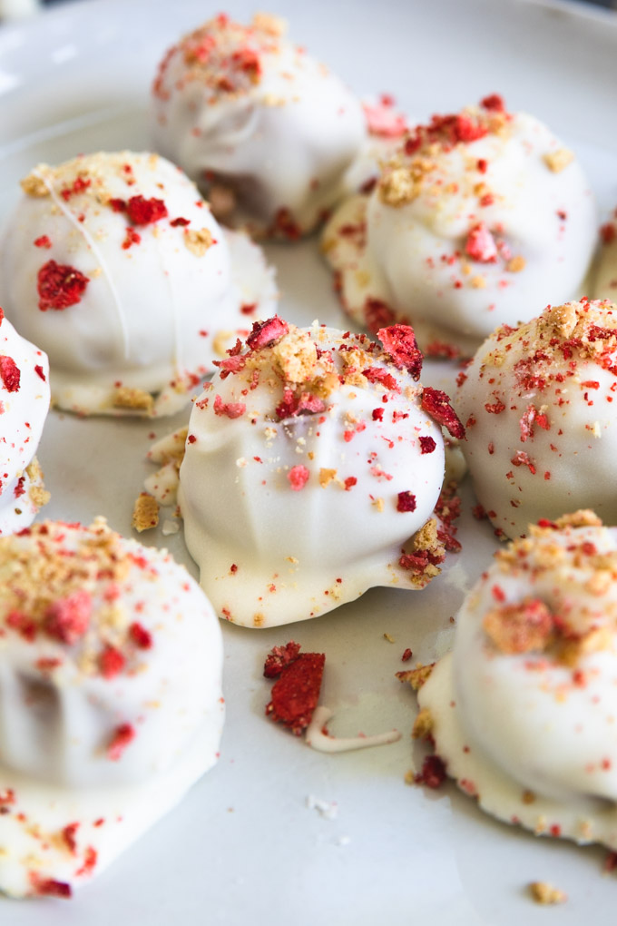 shortcake balls with graham cracker and crushed strawberries on top. 