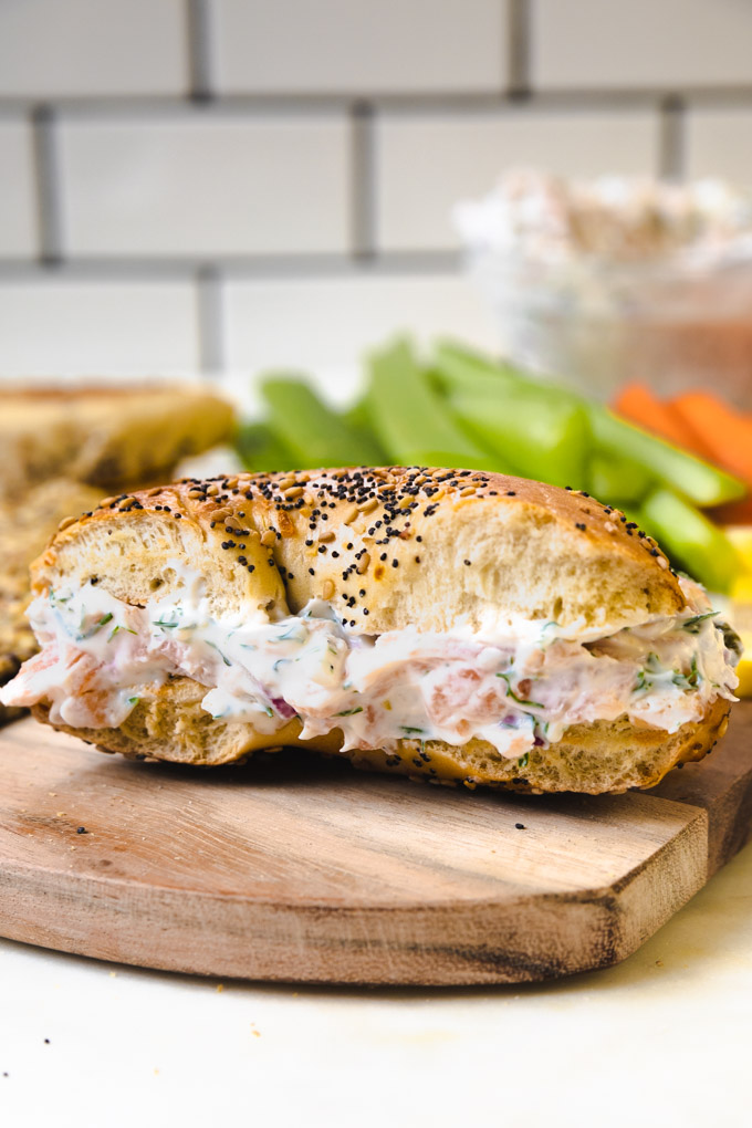 smoked salmon dip on a bagel folded into pieces. 