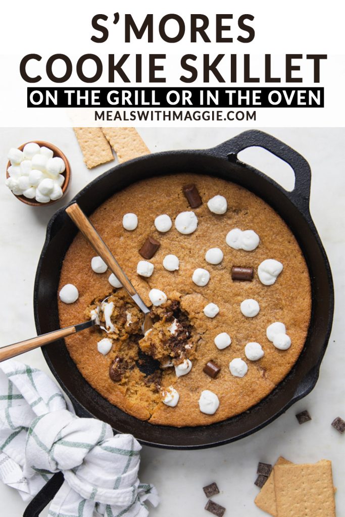 marshmallows and chocolate cookie in a cast iron skillet with text over it. 