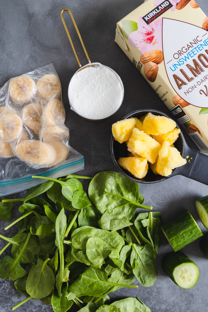 Green Superfood smoothie ingredients in separate containers. 