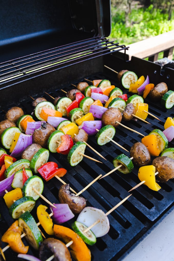 vegetable kabobs on a grill outside. 