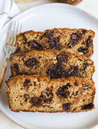 three slices on zucchini bread on a plate.