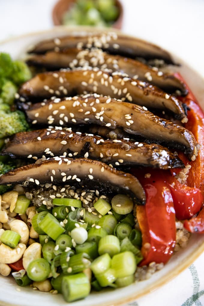 Sesame seeds on top of sliced portobello mushrooms.