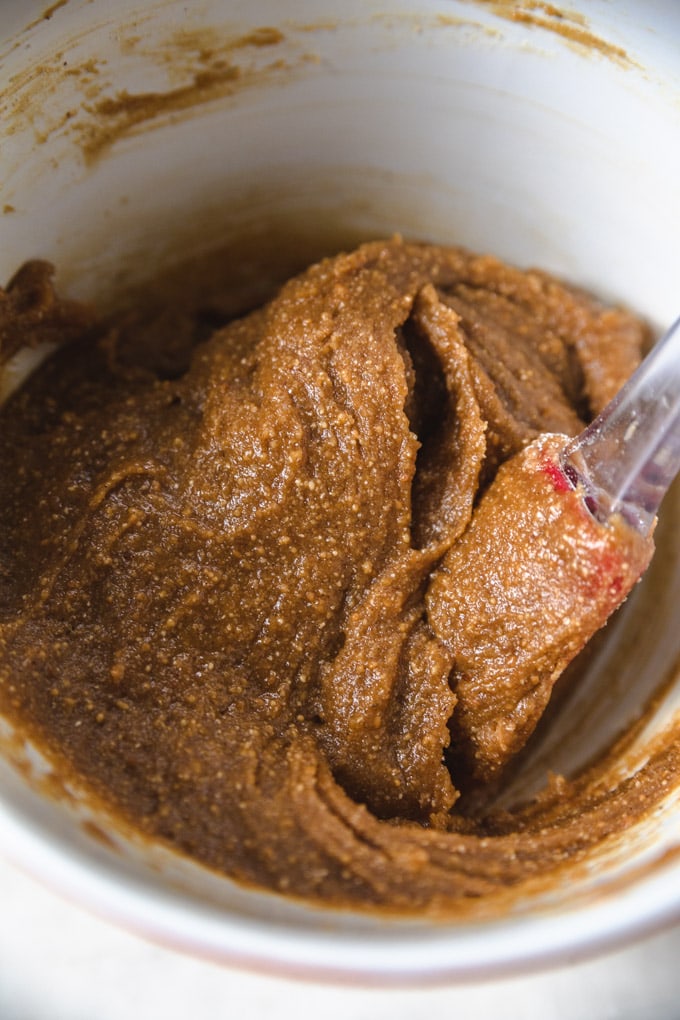 a bowl of cookie batter with a spatula.