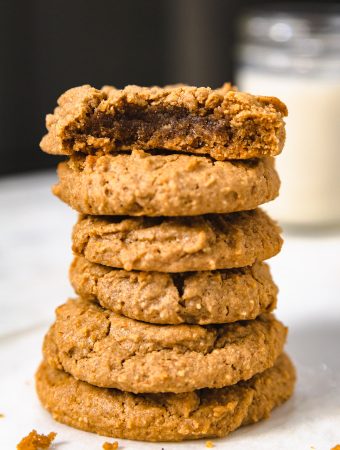 stack of peanut butter cookies with a bite mark.