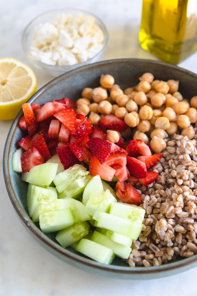 A plate of unmixed ingredients for farro salad.