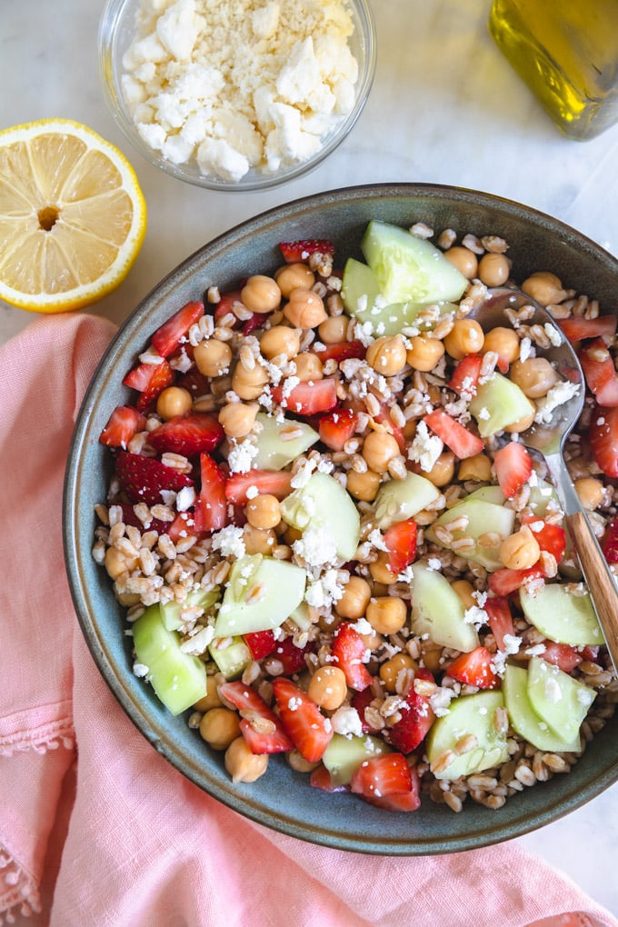 Strawberry Farro salad in a bowl with a spoon.