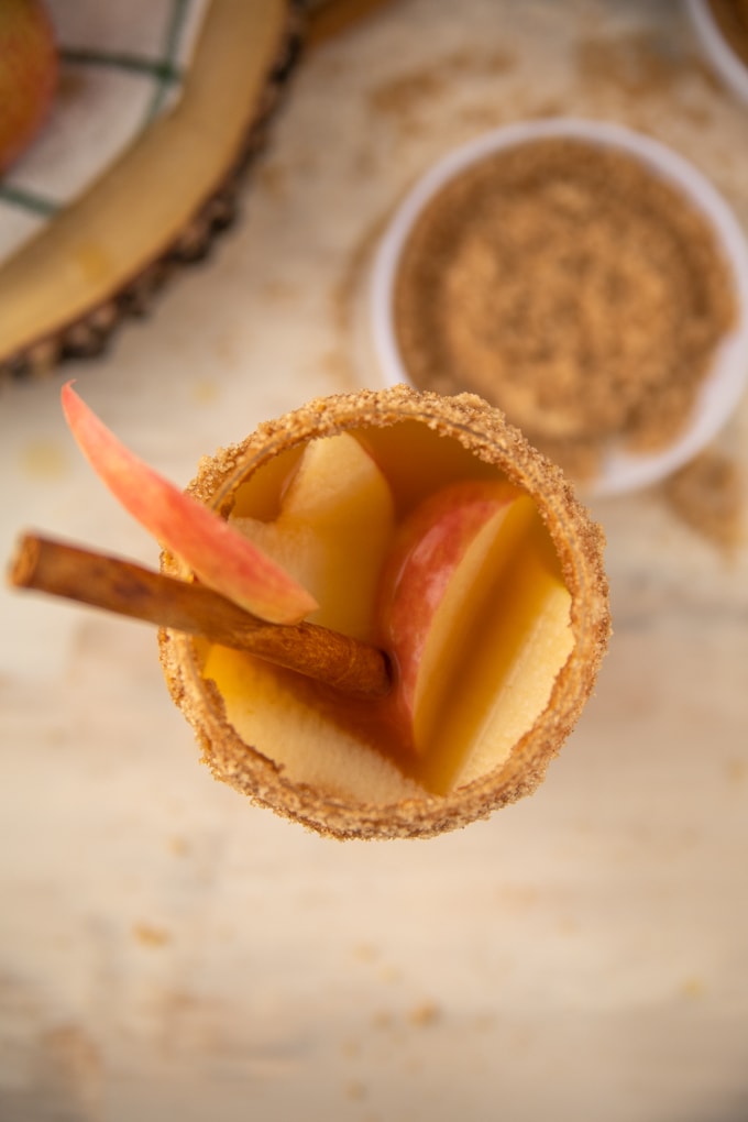 inside of a glass with apple cider and peanut butter whiskey.