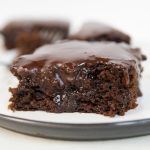 a pumpkin brownie on a plate with frosting on top.