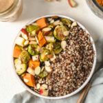 A buddha bowl filled with fall vegetables and quinoa.