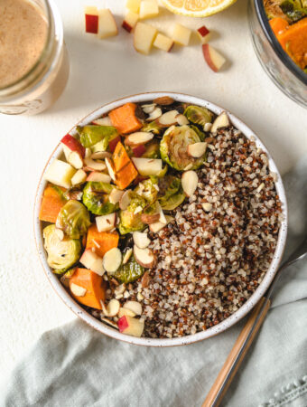 A buddha bowl filled with fall vegetables and quinoa.