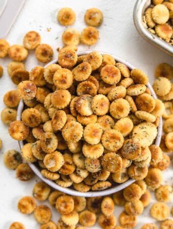 ranch seasoning oyster crackers overflowing out of a bowl.