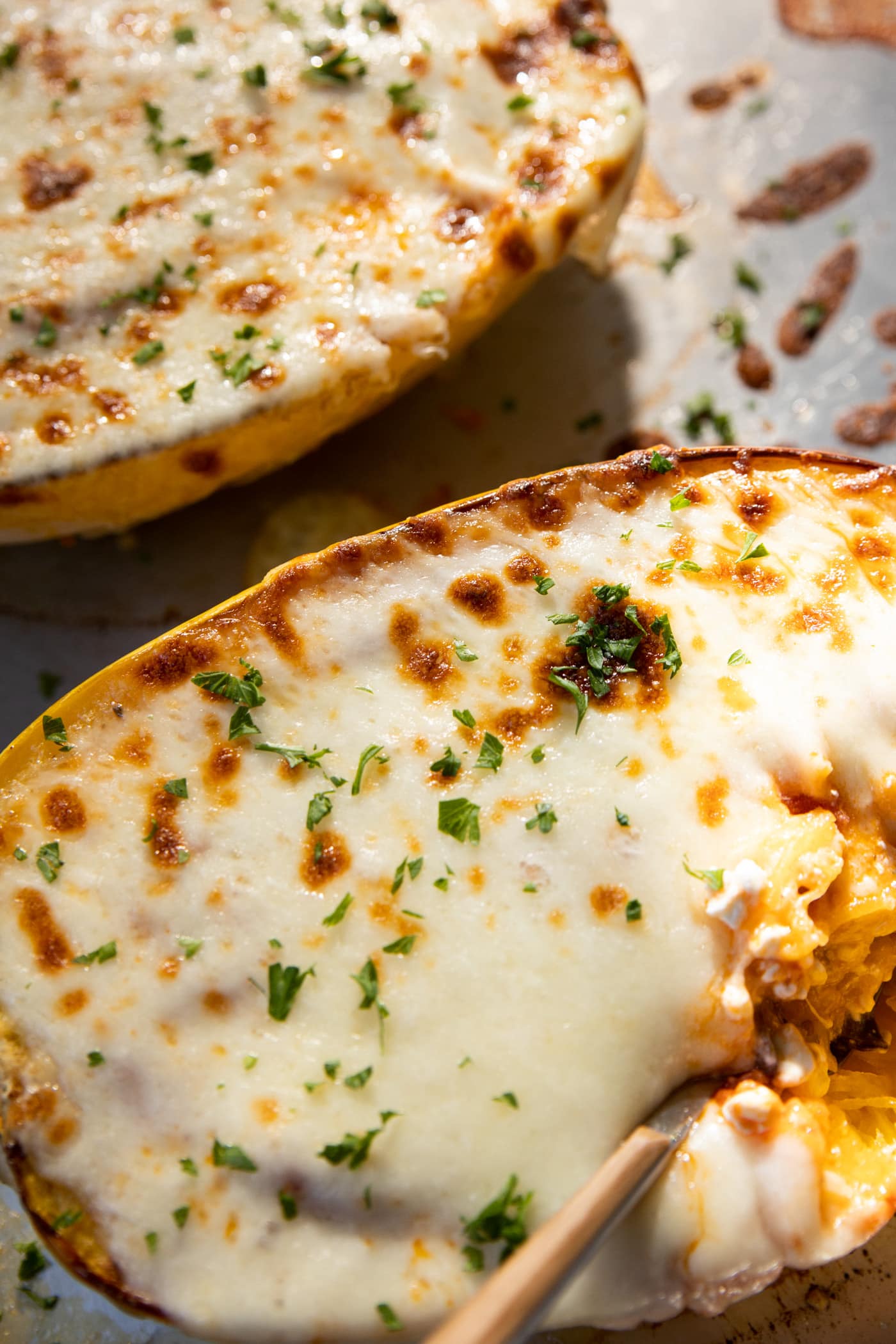 The inside of a stuffed spaghetti squash with a fork. 