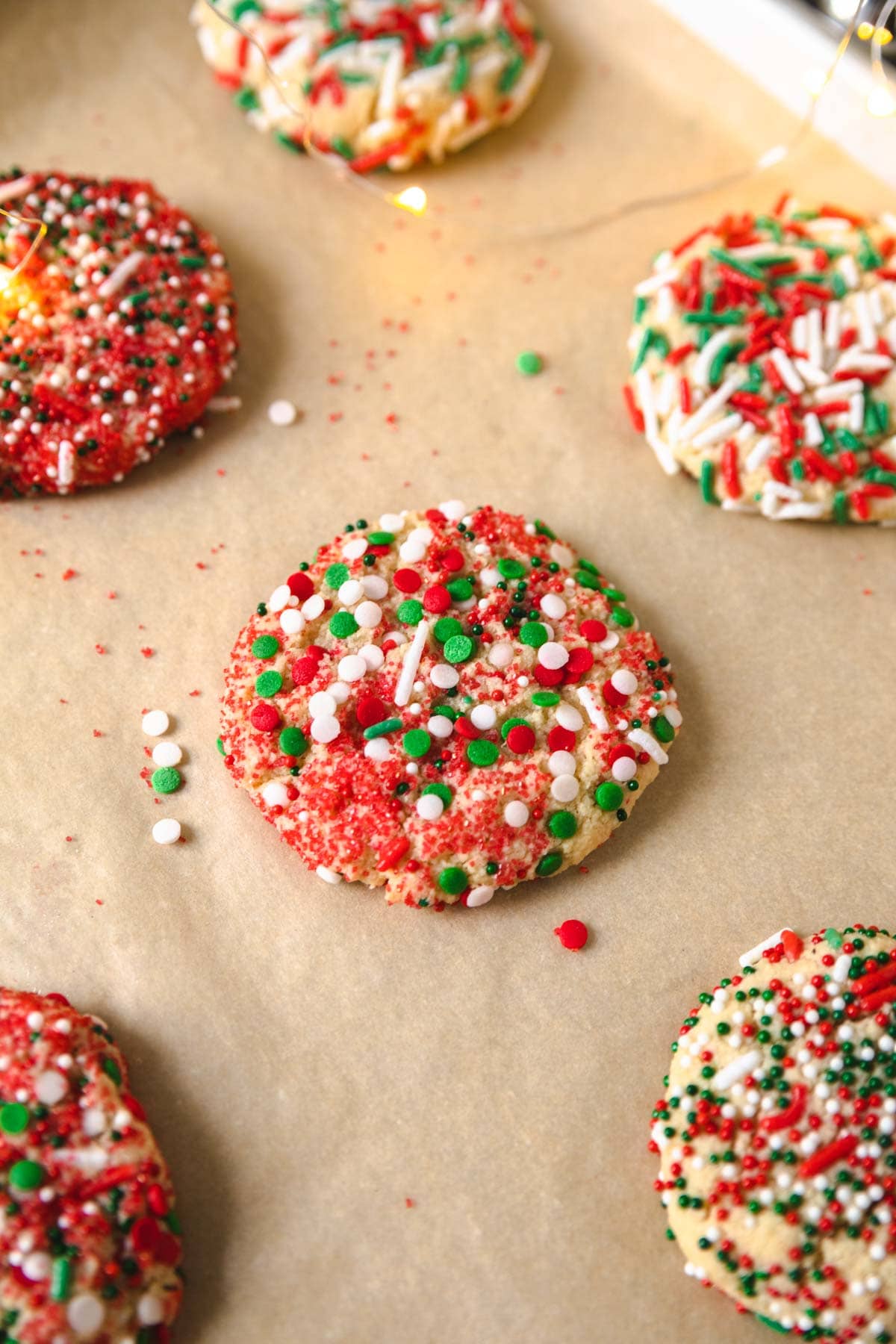 vegan and paleo sprinkle cookies on a sheet pan. 